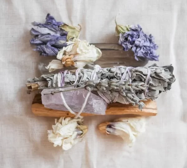 sage and palo santo with crystals and flowers